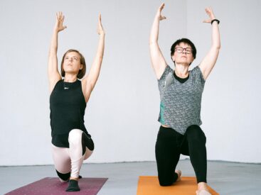 women kneeling on yoga mat